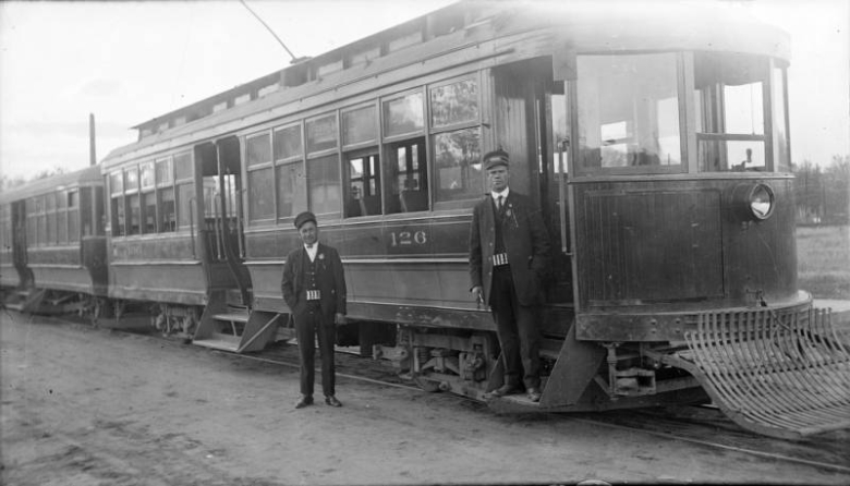 View of Denver Tramway Company car number 126 and a 500-series trailer (South Pearl Street Line), and men in conductor uniforms, in Denver, Colorado.