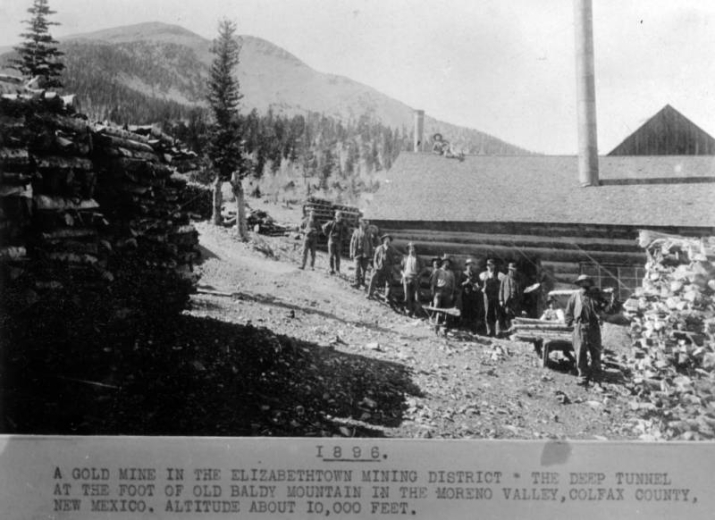 Miners pose at an gold mining complex, probably the Red Bandana Mine, in the Moreno Valley at the foot of Baldy Mountain, Colfax County, New Mexico.