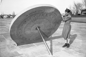 Young girl stands next to sundial in Hilltop Neighborhood's Cranmer Park, March 1941