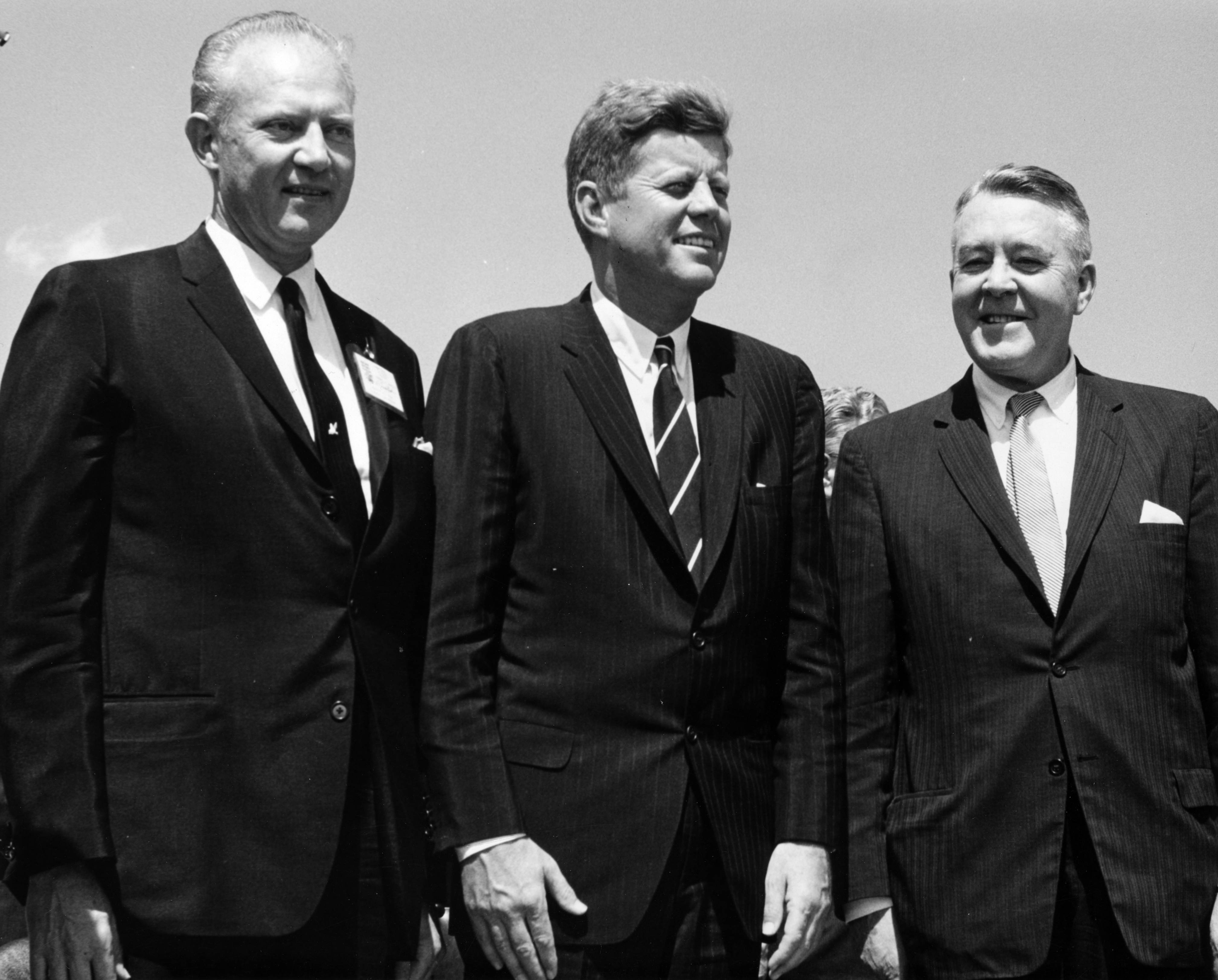 Governor Stephen McNichols, President John F. Kennedy, and U. S. Senator John Carroll pose outdoors at the Pueblo Public School Stadium in Pueblo