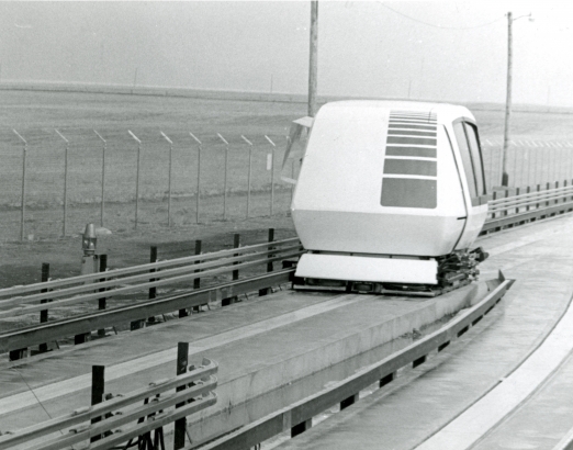 A personal air-cushion transit vehicle, designed by Transportation Technology Inc. of Denver, moves down a guideway at a test site east of Stapleton International Airport off I-70. February 16, 1972. (WH2129-2018-1305)