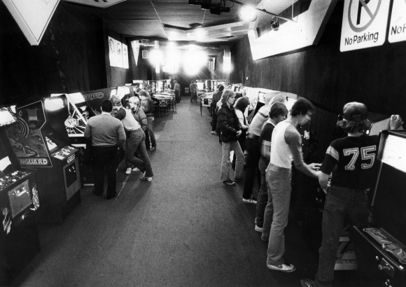 Video game enthusiasts line the aisle at Cinderella City's Funway Freeway arcade