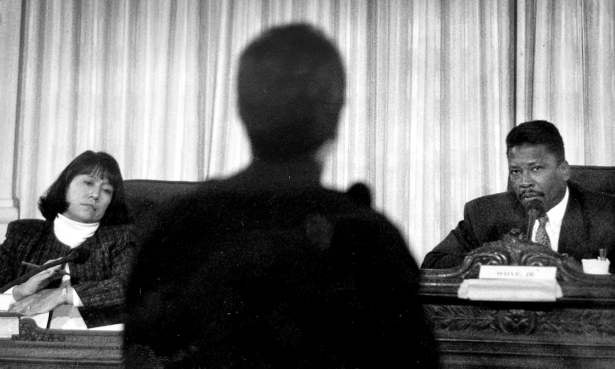 Left, Adrienne Benavidez and Chet Whye, both seated, face Lt. Gary Leuthauser at a Public Safety Review Commission meeting.