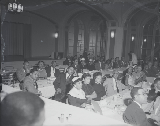 A community gathering in an auditorium 