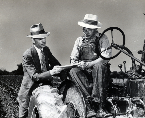 Photograph of a census enumerator assisting a farmer. Image courtesy of the National Archives.