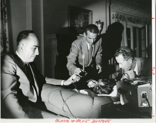 "Morey Bernstein, center, hypnotizes Ruth Simmons, a Colorado housewife, and tape records her memories of a previous lifetime as Bridey Murphy, 