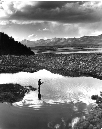 "Glory Holes for Trout mark the course of Willow Creek above the ghost town of Tincup, Colorado, in Gunnison National Forest. An angler tries for the big ones that lurk where a mining dredge went down to bedrock in search of placer gold.  