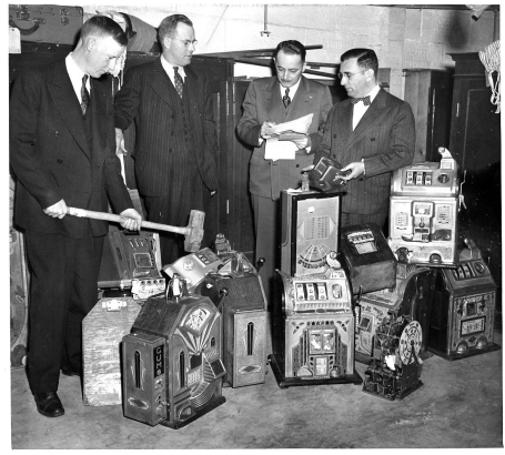 Gambling Bust: L to R Roger Smith,security and custodian police department; Captain John O'Donnell; John H. Winchell, clerk, District Court; Dave Rosner, Deputy District Attorney. [gambling]