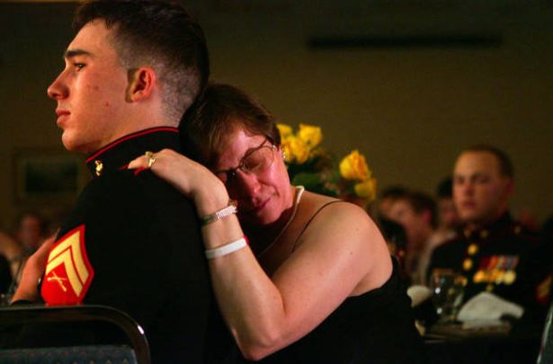 Jo Burns comforts Corporal Dustin Barker, 22, during a ceremony honoring the actions of fallen Marines.