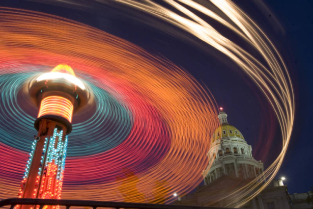 A time exposure captures the lights of the "Hurricane" ride on the mid-way set up on Broadway in front of the State Capitol on the third day of the four-day-long Taste of Colorado at Civic Center Park in downtown Denver on Sunday afternoon, Sept. 3, 20...