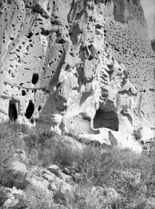 Volcanic tuff cliffs with natural caves enlarged to create living and ceremonial spaces by ancestral Pueblo Indians, Frijoles Canyon, Bandelier National Monument, New Mexico.