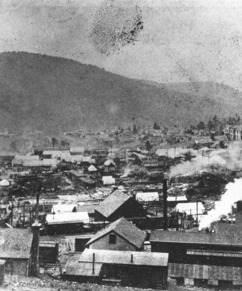 Cripple Creek, Colorado, after first fire on April 25, 1896; possibly view southwest taken from hillside near Midland Terminal Station; possibly Myers Avenue area; many canvas tents amidst debris remain from destructive fire; residences and houses are on distant opposite hillside.