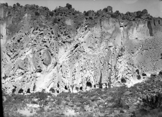 Soft volcanic tuff cliffside with natural caves, enlarged to create living and ceremonial spaces by ancestral Pueblo Indians, Frijoles Canyon, Bandelier National Monument, New Mexico.