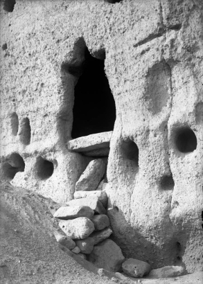 View of an enlarged entrance into a natural cave in soft volcanic  rock, Frijoles Canyon, Bandelier National Monument, New Mexico; occupied by ancestral Pueblo Indians between the 13th (thirteenth) and 16th (sixteenth) century.
