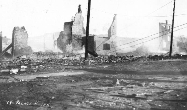 Brick rubble and partial walls of Palace Hotel, Bennett Avenue and Second (2nd) Street, destroyed by second fire of April 29, 1896, Cripple Creek, Colorado; smouldering debris.