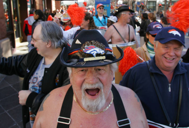Broncos "Barrel Man" Tim McKernan, cq,  leads over one hundred fans up and down the 16th Street Mall during a Kool 105 Parade to support the Denver Broncos in their game against the New England Patriots Saturday which will be the first play off game at...