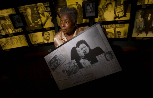 Terry Nelson, Senior Special Collections and Community Resource Manager for the Blair-Caldwell African American Research Library of the Denver Public Library holds part of a Rd. Martin Luther King Jr. exhibit that included a photograph of his wife Core...
