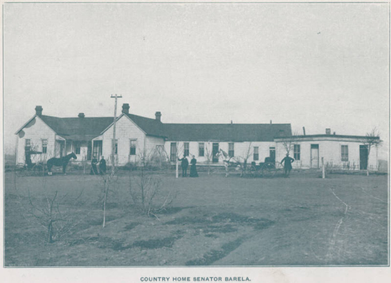View of Colorado Senator Casimiro Barela's country home  in El Moro (Las Animas County), Colorado. Shows a house with gabled roofs and an small cabin. Men and women pose near the house and near horse drawn carriages. Senator Barela poses right center with an unidentified woman.