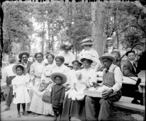 Outdoor portrait of an African-American family preparing for a picnic in a park in Denver, Colorado.