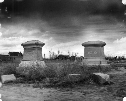 Mount Calvary Cemetery (later Denver Botanic Gardens), the Catholic section of Mount Prospect Cemetery in the Capitol Hill neighborhood of the City and County of Denver, Colorado, is overgrown with weeds; an obelisk-shaped monument has toppled to the ground in the foreground.  Names on the headstones: "Monahan" and "Taney."