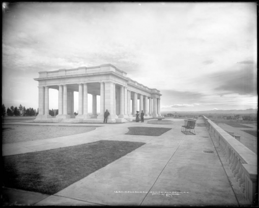 Exterior view of Cheesman Memorial Pavilion, Cheesman Park (formerly Congress Park), Denver, Colorado; designed by Marean & Norton firm (Willis A. Marean & Albert J. Norton), completed in 1909 as memorial to Walter Scott Cheesman using Colorado Yule marble; cement sidewalks, park benches, landscaping in process; view south towards distant Pikes Peak.