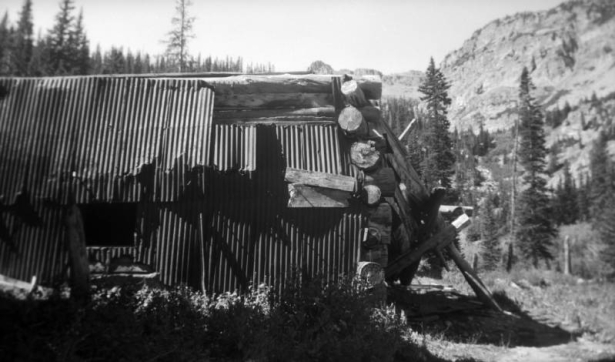 A dilapidated log and sheet metal shack stands on the verge of collapse at the Montezuma Mine, Pitkin County, Colorado.