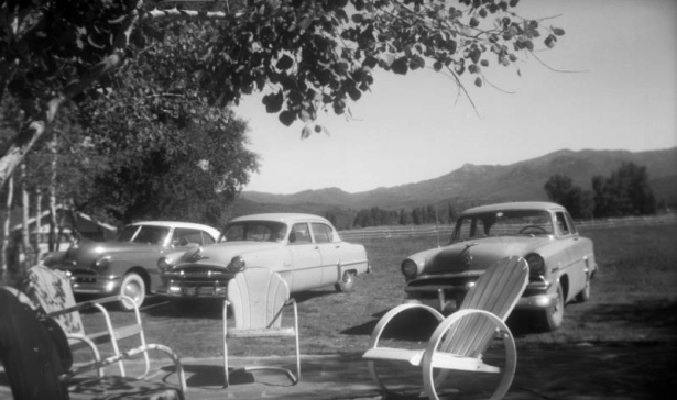 View of automobiles and metal patio chairs in Steamboat Springs, Routt County, Colorado.