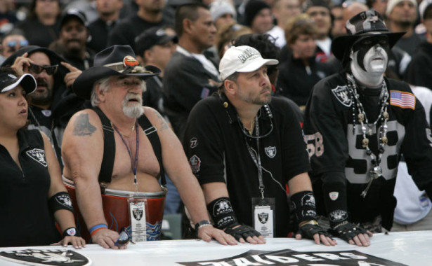 (BG1197} Denver Broncos Barrel Man hangs with a Oakland Raiders fans in the fourth quarter as the Broncos beat the Raiders 17-13 at McAfree Coliseum in Oakland, Ca., Sunday, Nov. 12, 2006. (BARRY GUTIERREZ/ROCKY MOUNTAIN NEWS) (((NAMES FROM OFFICIAL RO...