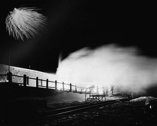 Silhouettes of members of the AdAmAn Club show in the illumination of fireworks on top of Pikes Peak, Colorado Springs, El Paso County, Colorado. Annual club festivities include a trek to the top of the 14,110 foot mountain to set off fireworks on New Years Eve outside the Cog Railway Terminal and observation deck.