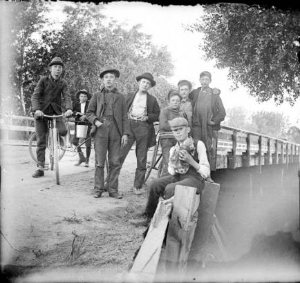 Outdoor portrait of boys with bicycles by the Alameda Avenue bridge in Denver, Colorado.