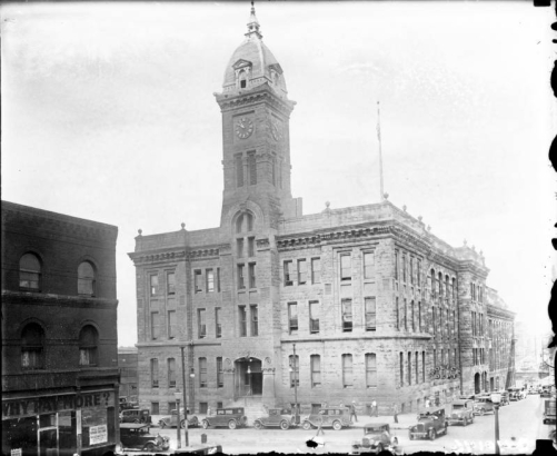 A view of the old City Hall located at 14th (Fourteenth) and Larimer Streets in Denver, Colorado. Shows a three story building with a clock tower, it was built in 1886 and demolished in 1936.