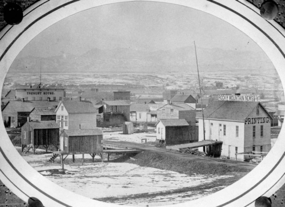 A view of the earliest Rocky Mountain News building in Denver, Colorado. The building was built on stilts in the bed of Cherry Creek, but the building, equipment, and many early issues of the News were lost in the flood of 1864. Photograph taken by an unknown photographer between 1859 and 1864.