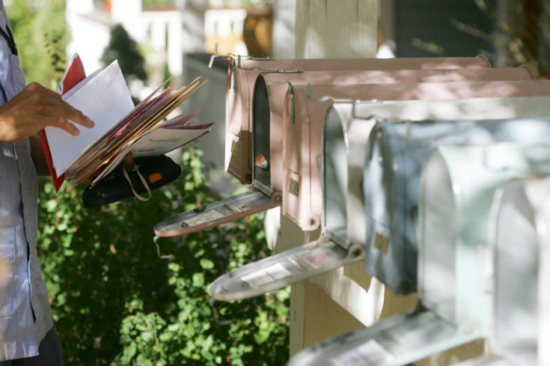 A mail carrier delivers mail to the cottage houses in the Poplar community in Boulder, Colorado on October 9, 2007, with 14 homes that surround a common grass area.  From their web site: "The project was initiated by a non-profit development group, the...