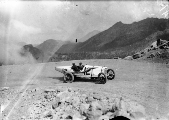 People ride in Duesenberg race car number "12" during the annual Pikes Peak National Hill Climbing Contest on the Pikes Peak Highway, El Paso County, Colorado.