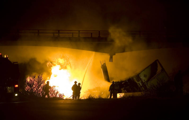 Photo by Dean Humphrey-- Grand Junction firefighters battle a tractor trailer crash in the westbound lanes of I-70 at the 26 1/2 Road overpass around 3:00 am today.  The highway and 26 1/2 road are closed indefinitely. The tractor was transporting 55 g...