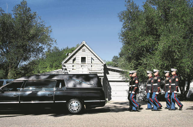 Marines escort the casket of Marine Lance Corporal Evenor Herrera to a gravesite in Eagle.