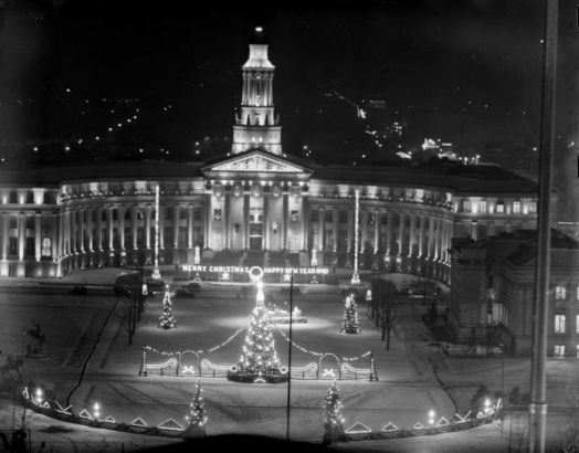 The Denver City and County Building is decorated for Christmas, Denver, Colorado. Sign reads: "Merry Christmas Happy New Year 1940."