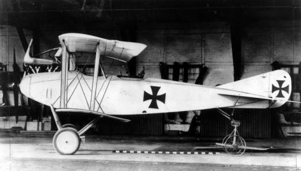 View of a German Albatros C-III airplane in a hangar; crosses are painted on the fuselage and tail.