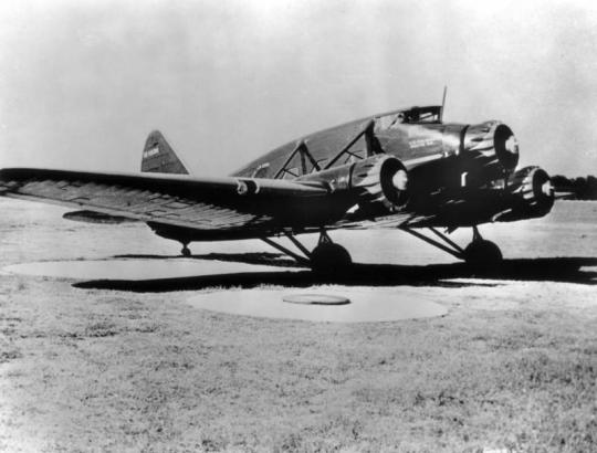 View of a three engine Stinson A passenger airplane with lettering: "[De]lta Airlines," and "U. S. Air Mail Route 2[?]."
