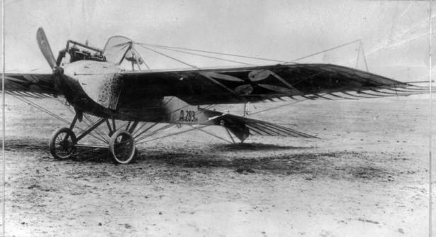 View of a German Jeannini - Taube monoplane with a cross painted on the wing, a reticulated pattern on the fuselage, and "A283" by the tail.