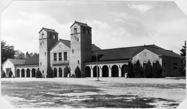 A view of the two story Spanish style pavilion designed by John J. Humphreys and William E. Fisher in City Park in Denver, Colorado. The building was erected on the west side of City Park Lake (Ferril Lake) in 1896.