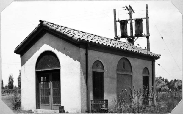 View of an adobe style water pump house at Berkeley Park in Denver, Colorado. The building has a tile roof.