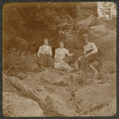 A family poses on a hillside in the mountains of Colorado.