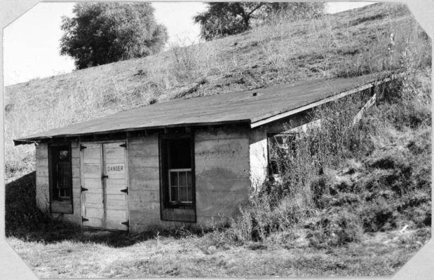 View of a water pump house at the Wellshire Golf Course (Wellshire Country Club) in Denver, Colorado. A sign that reads "Danger" is on a door of the building.