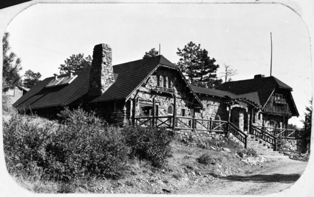 View of the Chief Hosa lodge, built as a restaurant by the city of Denver, at Genesee Park, part of the Denver Mountain Parks System (Jefferson County), Colorado. The stone masonry building has a covered entryway and a stone chimney.