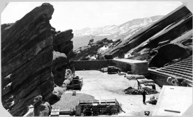 A side view of the stage and seating area at Red Rocks amphitheater under construction, Red Rocks Park, Morrison, Jefferson County, Colorado.