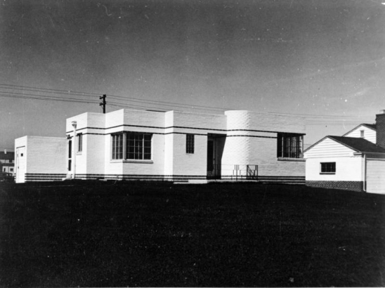 View of a Moderne style house in Denver, Colorado. The one-story brick masonry house has art deco accents with ornate brick work.