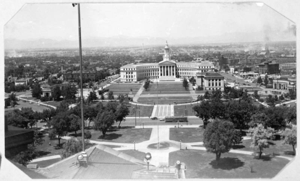 A view of Civic Center Park in Denver, Colorado. Shows the City and County Building, the Denver Public Library, the Voorhies Memorial and the Greek Amphitheater. The Denver skyline and the foothills are in the background.