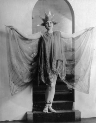 Lucille Ferry poses in a costume from the play "The Sunbird," produced in Denver, Colorado, by the Denver Community Players. Outfit includes gauze, strap sandals, and a sunburst hat.