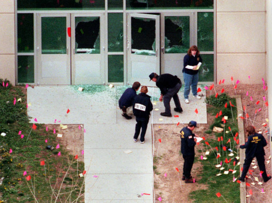Investigators tackle the intricate task of marking evidence where gunmen entered the school.
